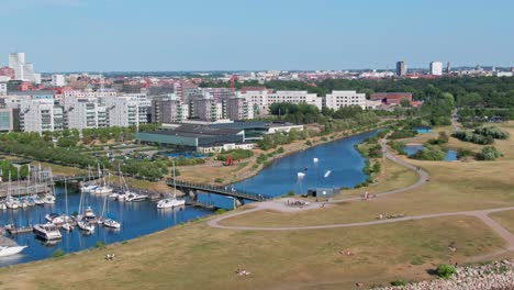 Sailing-boats-in-Western-harbour,-Malmö-with-view-of-one-of-the-canals-in-Malm?