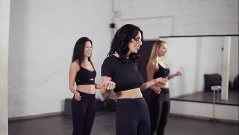 Group-of-three-attractive-women-learning-bachata-basic-moves.