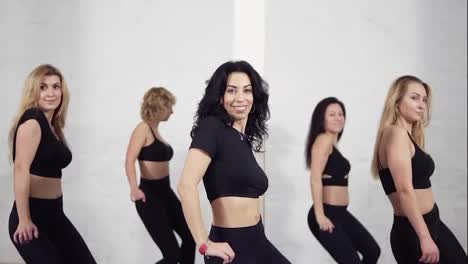 Group-of-female-dancers-learning-how-to-move-their-bodies-when-dancing-bachata.