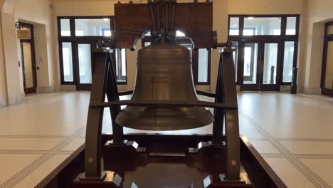 Looking-close-up-at-a-replica-of-the-Liberty-Bell-then-panning-across-from-left-to-right-and-backing-up-to-see-full-display-on-the-bottom-floor-of-the-Utah-State-capital-building