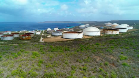 4k-Aerial-reveal-of-oil-storage-tanks-and-silos,-Bullenbaai-Oil-Terminal-on-the-island-of-Curacao