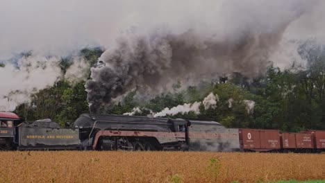 A-Side-View-of-a-Double-Header-Freight-Train,-Puffing-and-Blowing-Smoke-and-Steam-as-it-Passes-on-a-Fall-Day