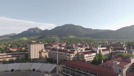 CU-Boulder,-Colorado-USA,-Revealing-Drone-Shot-of-University-Campus-and-Flatirons-Mountain-Hills-on-Sunny-Summer-Day