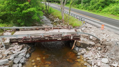 Lowering-Aerial-View:-Close-up-of-Flood-Damaged-Bridge-in-Plymouth-Notch,-VT