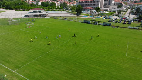 Professional-Soccer-Football-Match-Championship-In-Baska,-Krk,-Croatia---aerial-drone-shot