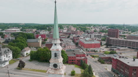 Drone-Push-In-Shot-Past-Church-Steeple-Revealing-Town-of-Bangor,-Maine