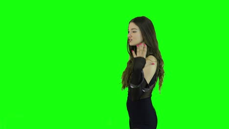 Side-view-of-a-charming-female-model-acting-and-talking-in-front-of-a-green-screen