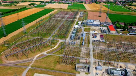 Electricity-Generating-Voltage-Poles,-Transmission-And-Substation---aerial-drone-shot
