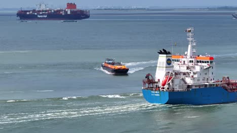 Busy-day-at-the-Westerschelde-wear-a-barge-and-coaster-crossing-each-other-while-a-container-vessel-sails-in-the-background