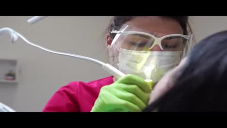 Woman-at-the-dental-hygienist-getting-professional-tooth-whitening-and-ultrasound-cleaning.-Shot-in-4k
