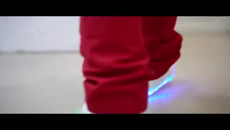 Closeup-view-of-boy's-leg-in-glowing-shoes-walking.-Sport-shoes-changing-colors-of-the-sole-or-bottom.-Shot-in-4k