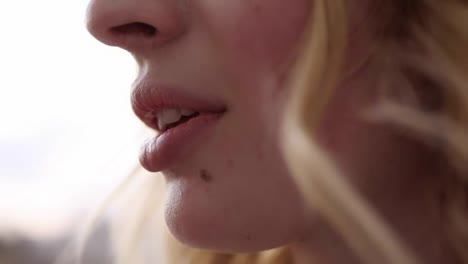 Extremely-close-up-of-woman's-mouth-eating-fresh-strawberry.-Beautiful-female-lips.-Blonde-haired-caucasian.-Side-view