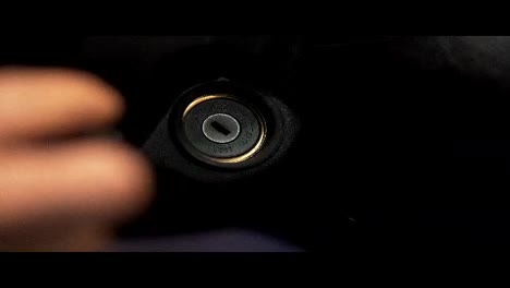 Man-turning-ignition-key-in-car.-Close-up-view