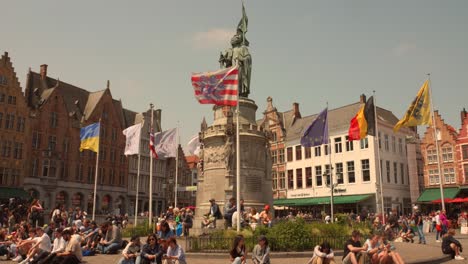 Tourists-at-Pieter-de-Coninck-statue-on-mains-square-of-Bruges,-Belgium