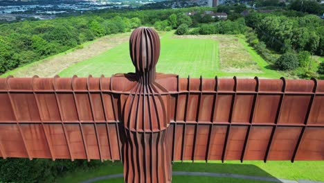 Close-dramatic-aerial-view-of-the-Angel-of-the-North-statue,-then-to-a-high-wide-view
