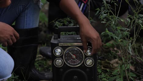 People-Tuning-And-Listening-To-Radio-In-Asian-Jungle