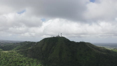 Cinematic-aerial-footage-of-a-tower-on-a-rainforest-hill-close-to-Cebu-in-the-Philippines,-Asia,-Drone