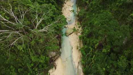 Revealing-cinematic-drone-shot-of-a-river-in-the-rainforest-of-Cebu-in-the-Philippines,-Asia,-Aerial