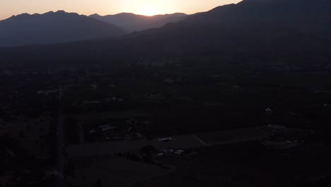Reverse-pullback-tilting-up-aerial-shot-of-the-famous-"Pink-Moment"-in-Ojai-Valley,-California