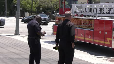 firefighters-chat-next-to-truck