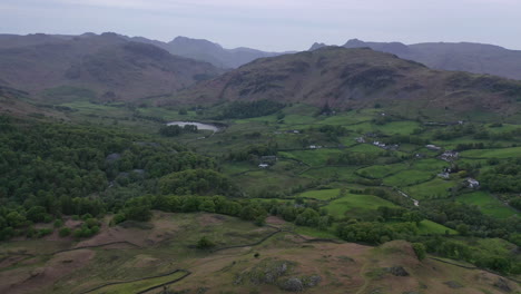 Aerial-flight-at-sunset-over-Little-Langdale-village-from-Holme-Fell
