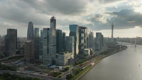 Guangzhou-Alibaba-group-office-building-complex-by-the-Zhujiang-river-coast-with-Canton-tower-in-background-on-a-beautiful-cloudy-sunset