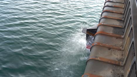 Ships-bow-penetrating-through-sea-surface-while-moving-ahead---Closeup-detail-of-bow-with-water-splashing-around
