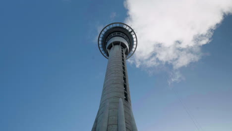 A-wide-shot-time-lapse-looking-up-at-the-Sky-Tower-in-Auckland,-New-Zealand