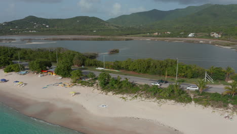 Seitenansicht-Aus-Der-Luft,-Grünes,-Offenes-Dach,-Allradantrieb-An-Der-Küste-Von-Antigua-Und-Bermuda,-Umgeben-Von-Meer-Und-Grüner-Natur-In-Der-Karibik