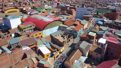 Aerial-view-over-a-parade-in-the-streets-of-historic-Potosi,-Bolivia