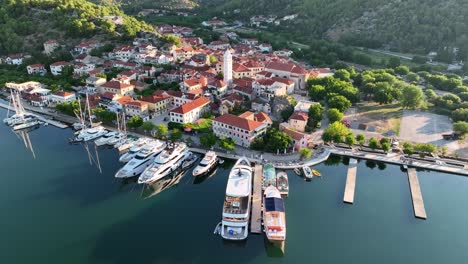 Aerial-drone-video-slowly-flying-to-the-left-and-rotating-around-the-old-town-of-Skradin-in-Croatia-as-birds-fly,-near-Krka-National-Park