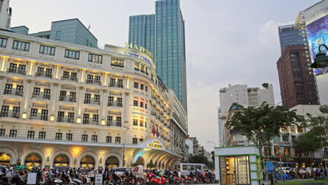 Capture-the-vibrant-traffic-scene-in-front-of-the-iconic-Majestic-Hotel-in-Saigon,-Vietnam