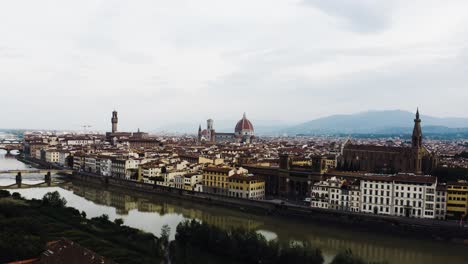 Long-aerial-shot-flying-over-Florence,-Italy-showing-the-multitude-of-buildings-that-house-the-population