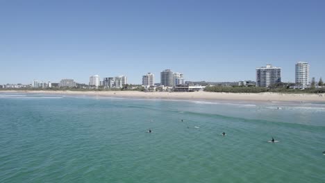 Swimming-on-Maroochydore-Beach,-Sunshine-Coast,-Queensland,-Australia,-Aerial-Pullback-Shot