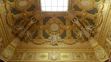 Beautiful-ceiling-decorated-with-sculptures-and-rich-art,-inside-the-Louvre-Museum,-France