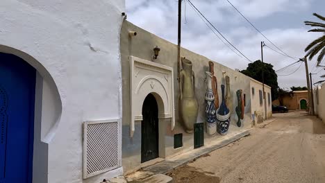 Walking-along-colorful-Djerbahood-street-art-location-of-Djerba-island-in-Tunisia
