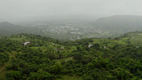 Aerial-drone-camera-moving-over-forest-Mountains-with-lots-of-waterlogged-fields-in-the-middle-of-the-mountain,-a-wonderful-sight-in-the-rainy-season