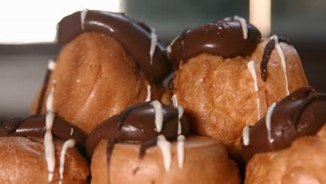 Close-Up-of-Profiteroles-Choux-Pastry-with-Whipped-Cream-Filling-and-Chocolate-Top