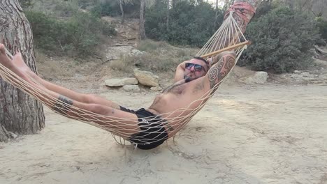man-in-a-hammock-on-the-beach