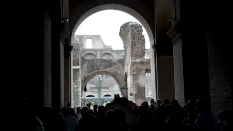 Silhouette-Of-Tourists-Walking-Through-The-Vomitorium-Inside-The-Colosseum-In-Rome