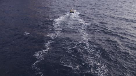 tracking-shot-of-fishing-vessel-at-ocean-near-Cap-Formentor-Mallorca,aerial