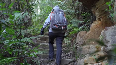 Indigenous-woman-climbing-up-stairs-while-backpacking-through-the-Australian-bush