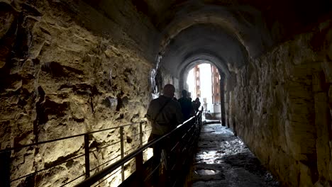 Tourists-Exploring-Underground-Tunnel-Leading-To-Colosseum-Arena-Floor-In-Rome
