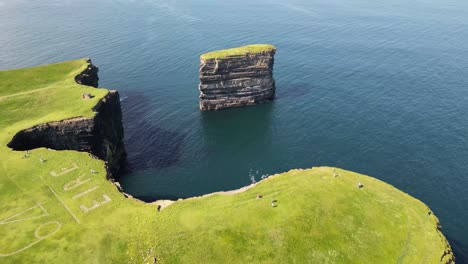 Drone-shot-flying-around-Downpatrick-Head-from-right-to-left-showing-the-64-Eire-sign