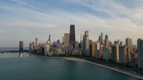Chicago-USA-at-Sunset,-Aerial-View-of-Cityscape-Skyline-and-Central-Towers-From-Michigan-Lake,-Drone-Shot