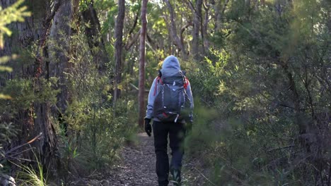 Indigenous-woman-backpacking-through-the-Australian-bush-on-a-cold-morning