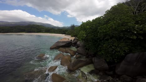 Fpv-drone-flying-on-a-beautiful-beach-in-Seychelles-on-an-Island-Mahe,-video-of-incredible-trees,-Seychelles-rocks,-seaside,-and-surrounding-Seychelles-landscapes
