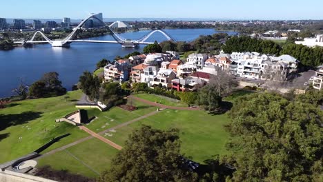 Drone-Aerial-View-travelling-sideways-over-East-Perth-foreshore-park-with-Matagarup-Bridge-to-wider-expanse-of-Swan-River