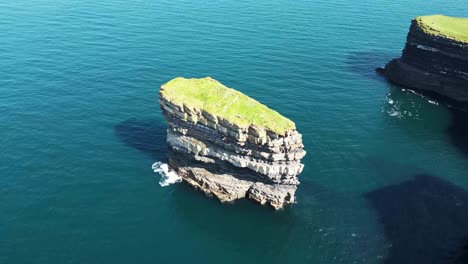 Stable-Drone-shot-looking-down-on-Downpatrick-Head-while-the-waves-crash