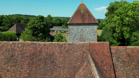 Crawling-boom-shot-of-the-roof-and-tower-of-St-Lawrence-the-Martyr-church-in-Godmersham,-Kent